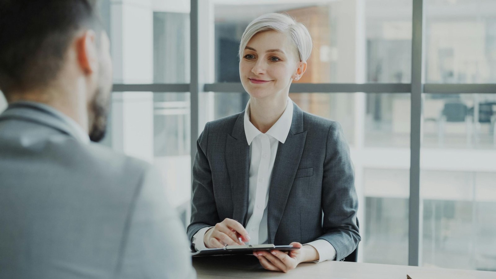 Immigration Confident woman interviewing candidate in a modern office. Ideal for business and HR visuals.